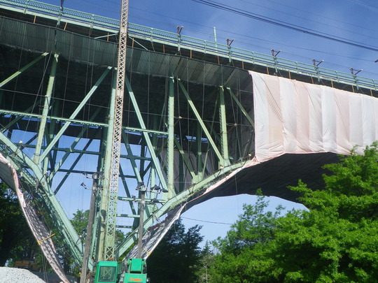 View of Dr. José Rizal Bridge with containment tent installed under and along the side during repainting work.