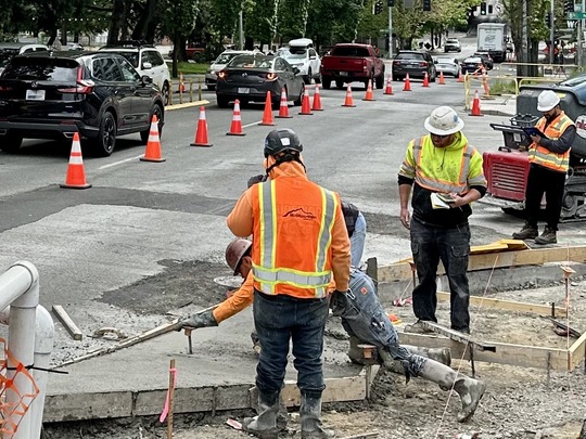 Image showing construction workers installing new sidewalk for the Denny Way Paving Project
