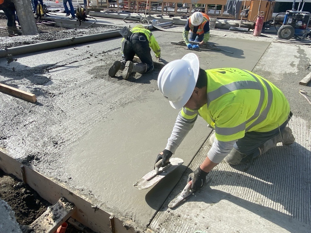 Crews smooth out new concrete on NE 43rd St. 