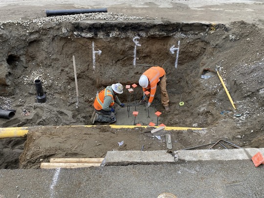 Crews install support beams for utilities