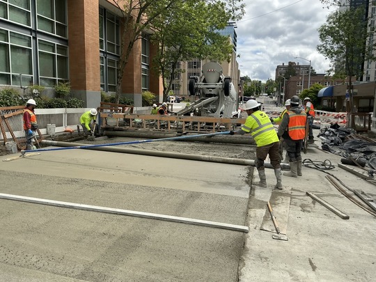 Crews pour new concrete on NE 43rd St. 