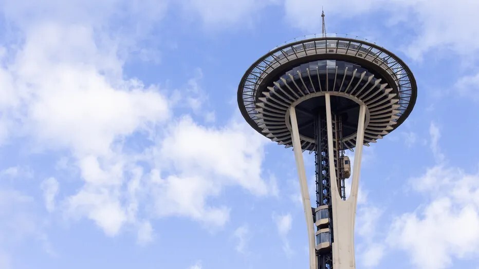 Space Needle with new elevators and clouds in the background