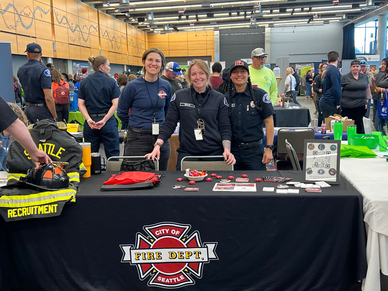 Firefighters and professional staff at a women in trades event