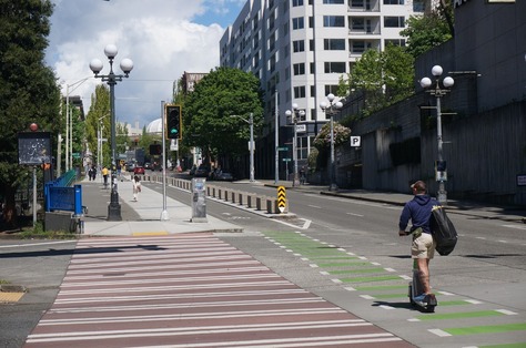 Person riding a scooter on a new protected bike lane