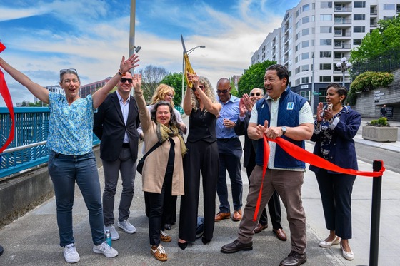 People celebrating the ribbon cutting of the completion of the pedestrian and bicycle improvements on Pike and Pine streets