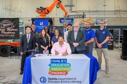 Mayor Harrell and leaders smile after signing FEPP Levy.