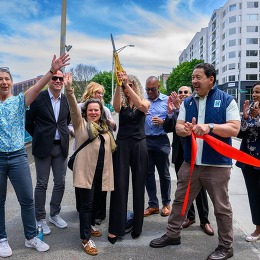 Group cutting red ribbon and celebrating new street improvements