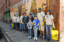 Multigenerational group with cleaning supplies volunteering at Day of Service