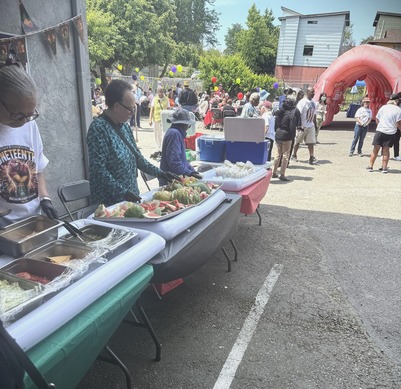 Tables with BBQ food being served at an outdoor event