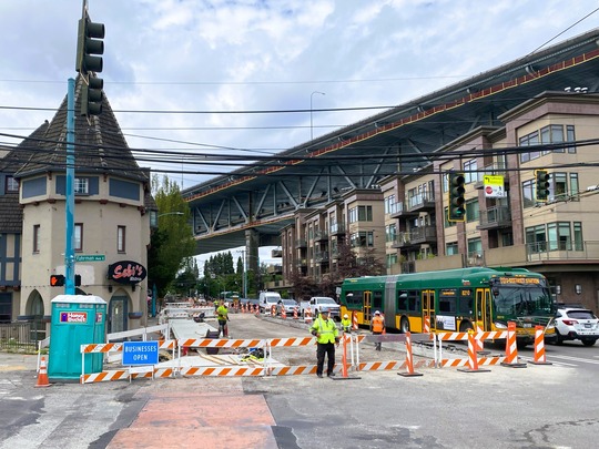 Crews direct traffic around concrete paving on Eastlake Ave E. 