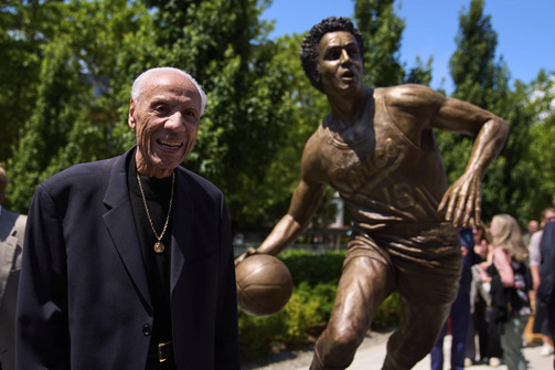 Lenny Wilkens stands next to his statue outside Climate Pledge Arena