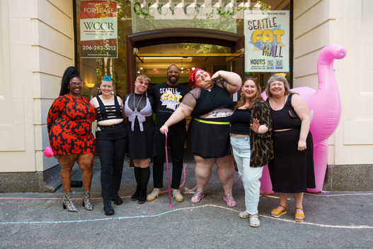 People smiling outside of Seattle Fat Mall
