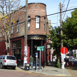 A brick building with round front on a street corner