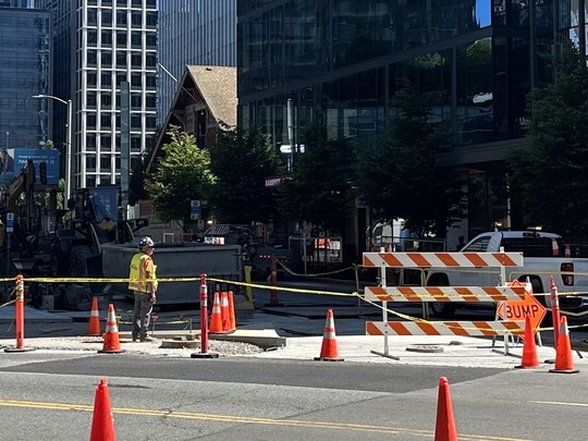 Image showing sidewalk work on Denny Way including orange cone, construction crew and construction vehicles