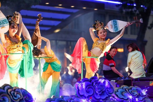 People dancing in the parade at the Seafair torchlight parade