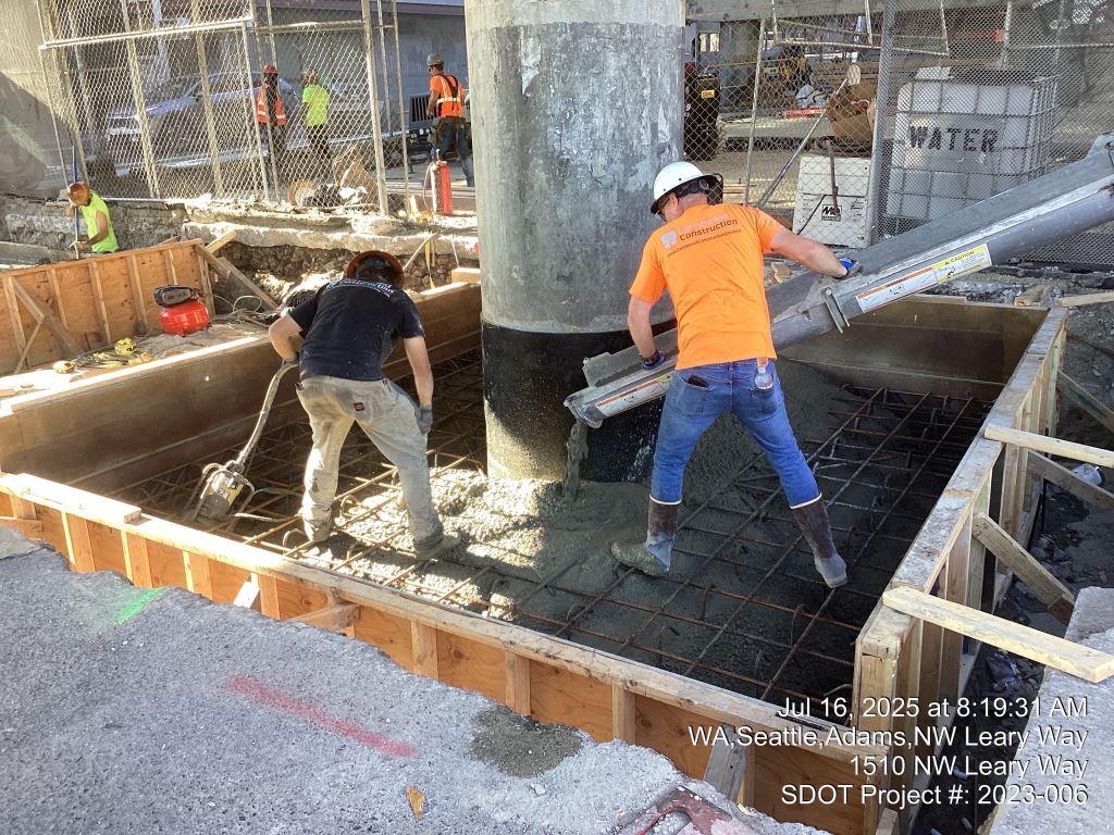 Crews pour seismic retrofit concrete for the Leary Way Bridge’s footings. Image taken July 16, 2025.