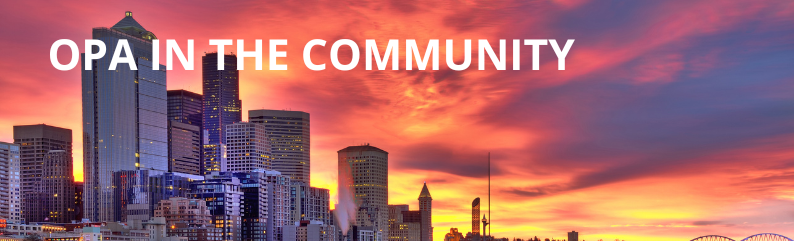 Seattle's waterfront Skyline downtown at sunset with the words 'OPA in the Community' written in white text at the top