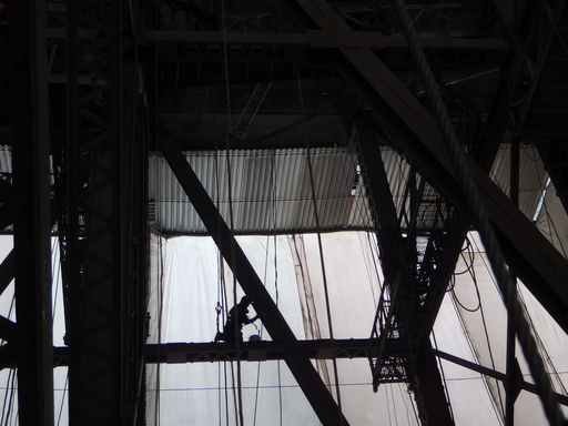A crew member removes paint from the José Rizal Bridge