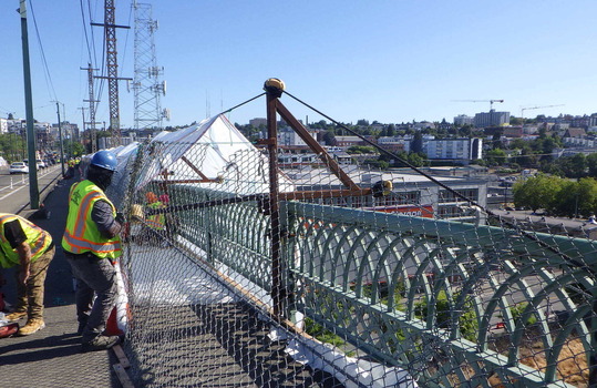 Crew members work on the deck of the José Rizal Bridge.