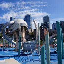 jellyfish playground structure with downtown buildings in the background
