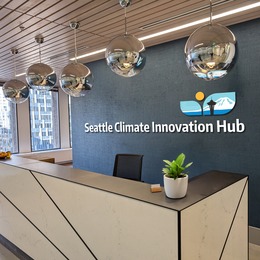 empty front desk with seattle climate innovation hub behind it on the wall