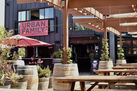 Exterior storefront view of Urban Family Brewing with outdoor seating
