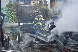Firefighters put water on a fire.