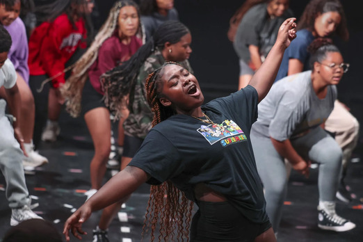 A person singing during a rehearsal