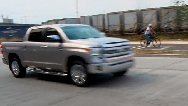 A truck and bike travel down East Marginal Way South
