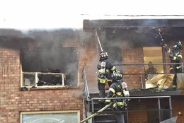 Firefighters extinguishing a fire in an apartment building