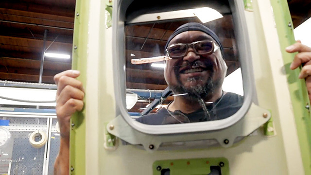 Pioneer Industries employee holds a door panel