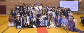 Picture of program participants and Seattle Youth Employment Program staff poised for a group photo in a gym.