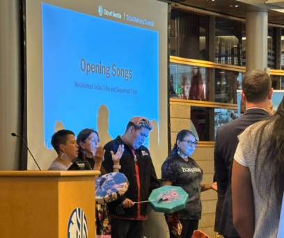 Muckleshoot Tribal Members doing an opening prayer with handheld drums