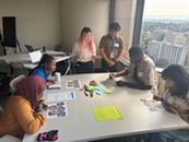Two youth interns facilitating an activity with a group of other interns