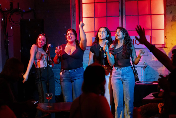 A group of people singing karaoke