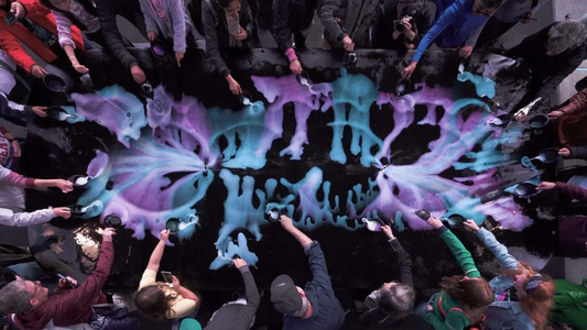 People participating in a collaborative paint pour