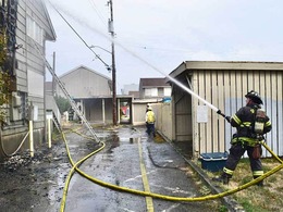 Firefighters putting water on a building fire.