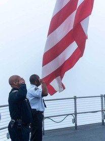 Fire Chief and Police Chief saluting the American flag