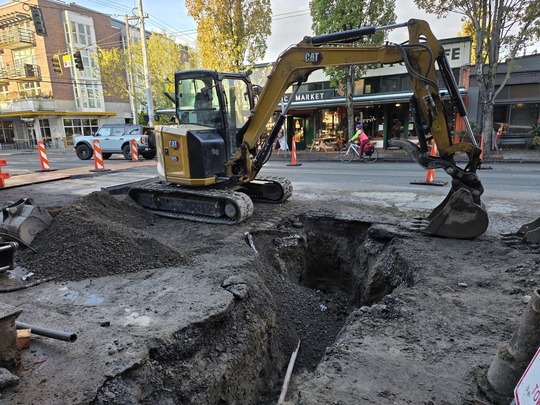 Crews dig trenches to reach underground water lines.  