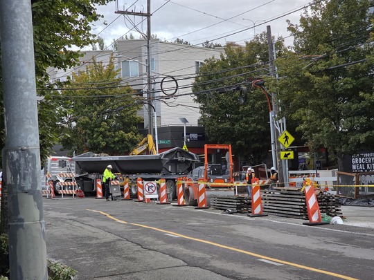 Crews consolidate paving equipment and materials in their staging areas. 