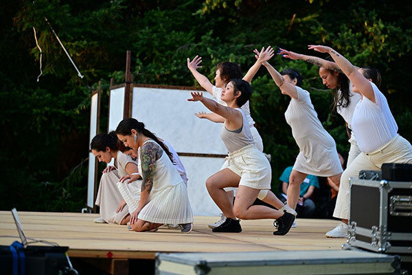 group dancing on a stage in a Seattle park