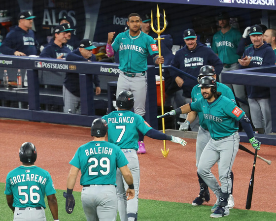 Seattle Mariners players celebrate a scoring play