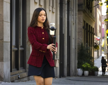 wman with brown hair holds a phone with a tripod in pioneer square