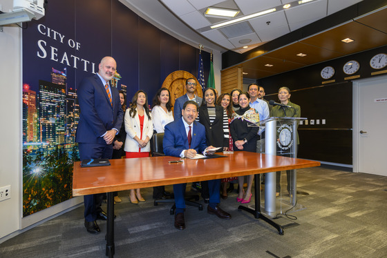Mayor Harrell signing EO with leaders behind