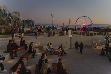 People sitting on outdoor benches at the Overlook Walk