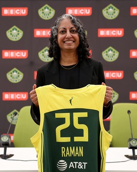 Sonia Raman holding up a storm jersey with her name on it