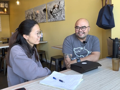 Jiaxin and Chong sit at a table in Ooink Capitol Hill 