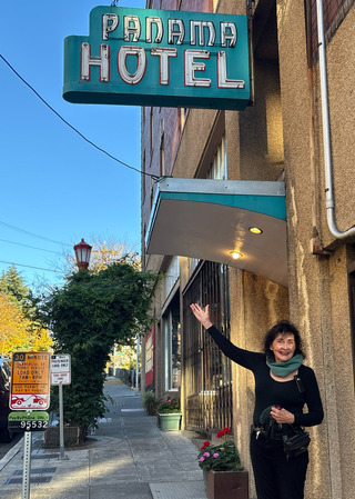 Jan Johnson standing under the Panama Hotel sign