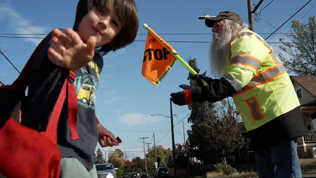 Thomas Mitchell helps students cross a Seattle street