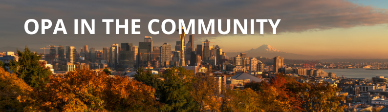 Seattle skyline in the fall at sunset with dark clouds and an orange glow of sun. OPA in the Community is written in white, bold font.